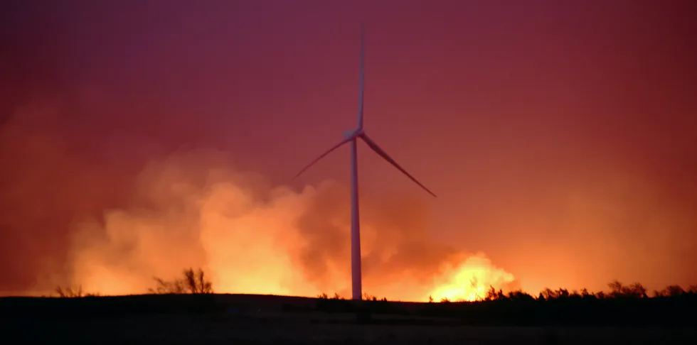 The Rhea fire rages behind a wind farm near Seiling, Oklahoma, in 2018