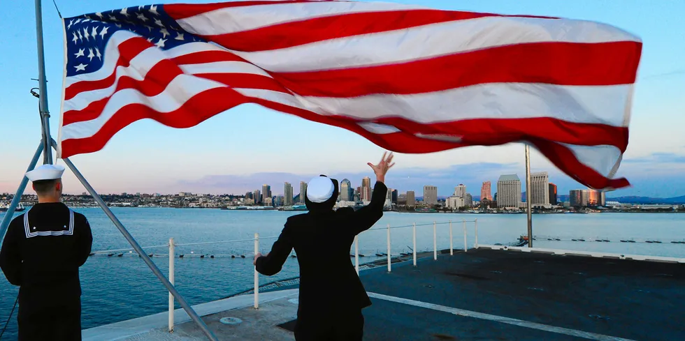 The US flag is lowered during evening colours aboard the aircraft carrier USS Ronald Reagan off California