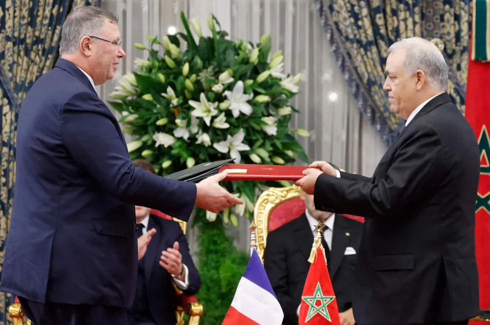 TotalEnergies chief executive Patrick Pouyanne (left) exchanges signed documents with Morocco’s Interior Minister Abdelouafi Laftit (right) during their meeting in Rabat on Monday.
