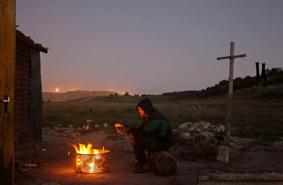 Deforestation: a wood fire used for cooking in a poor township near Cape Town, South Africa