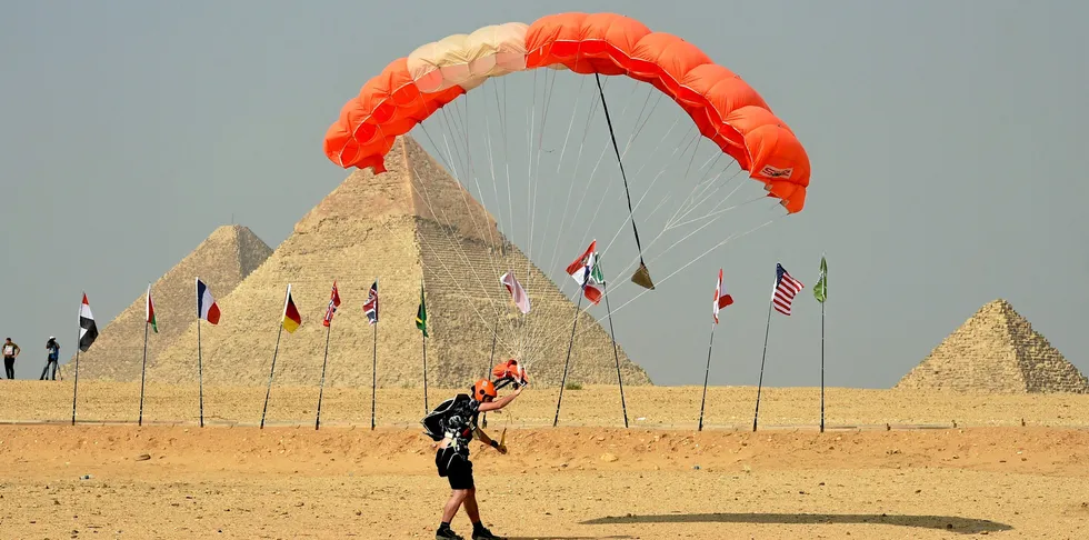 A skydiver lands near the Great Pyramids of Giza during an air show on the outskirts of the Egyptian capital Cairo
