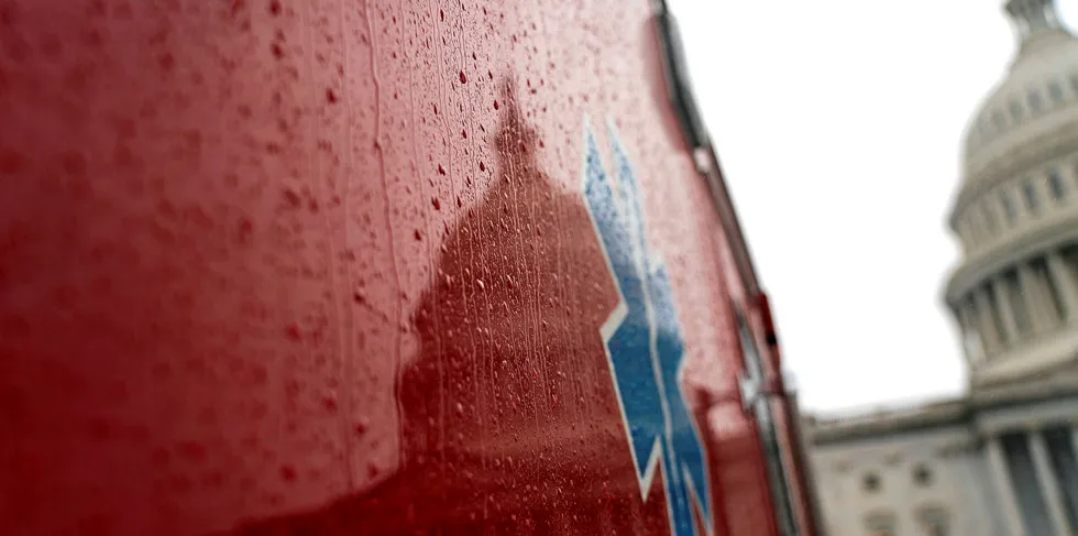 The US Capitol Building is reflected in on the side of an ambulance on March 25, 2020, in Washington, DC.