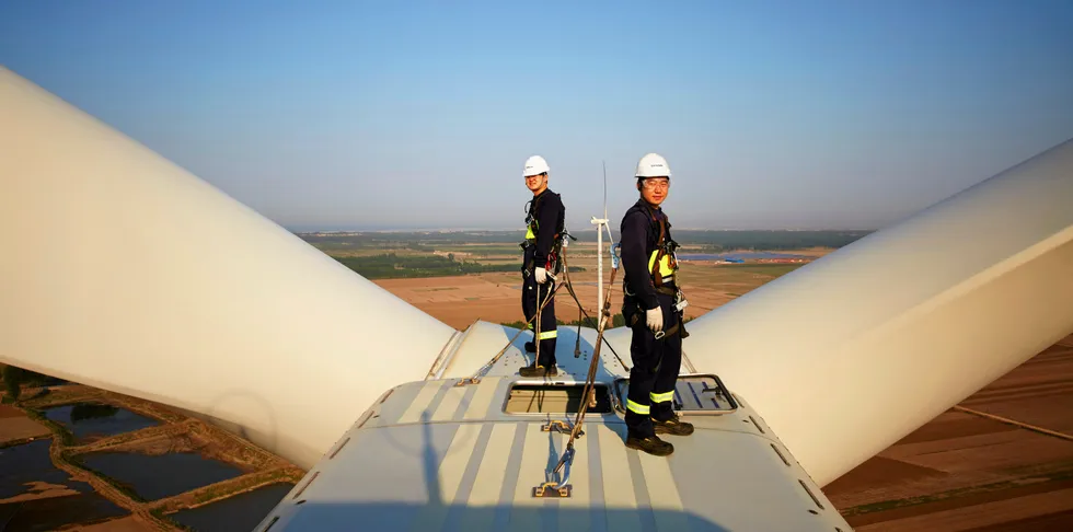 Chinese workers on Vestas turbine.