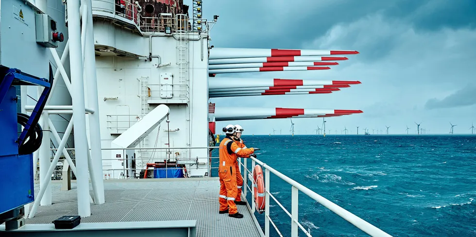 Crew on the deck of the component-laden Fred Olsen Windcarrier Brave Tern wind turbine installation vessel