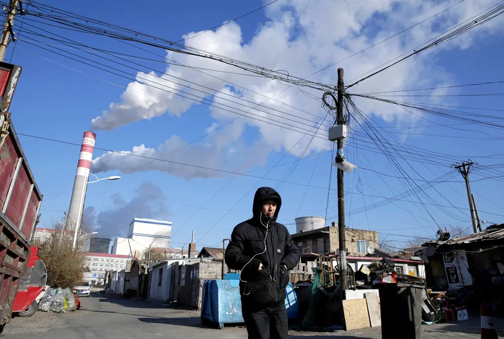 Eye-watering costs: smoke billows from stacks at a coal-fired power station in China