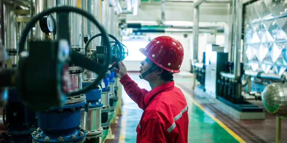 A Sinopec worker operating a geothermal heat pump in Heibei province, China.