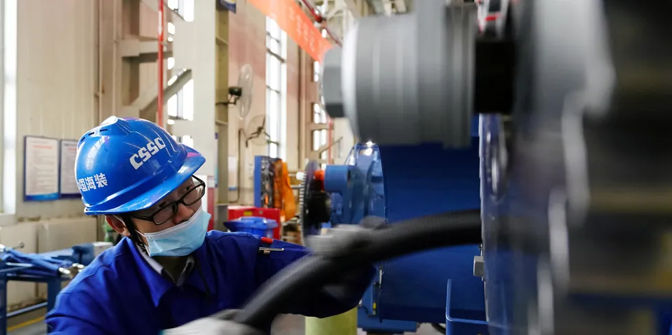An employee works on the assembly line at a branch of CSSC Haizhuang Windpower Co.
