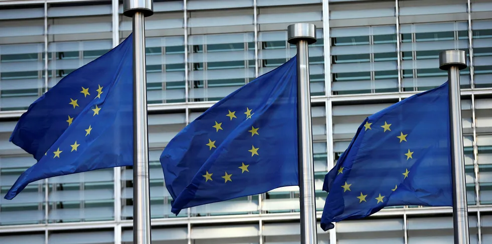 EU flags fly outside the European Commission headquarters building.