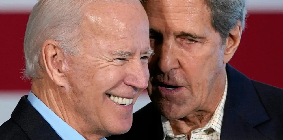 John Kerry speaks into Joe Biden's ear while campaigning for the former vice-president ahead of primary elections in December last year.