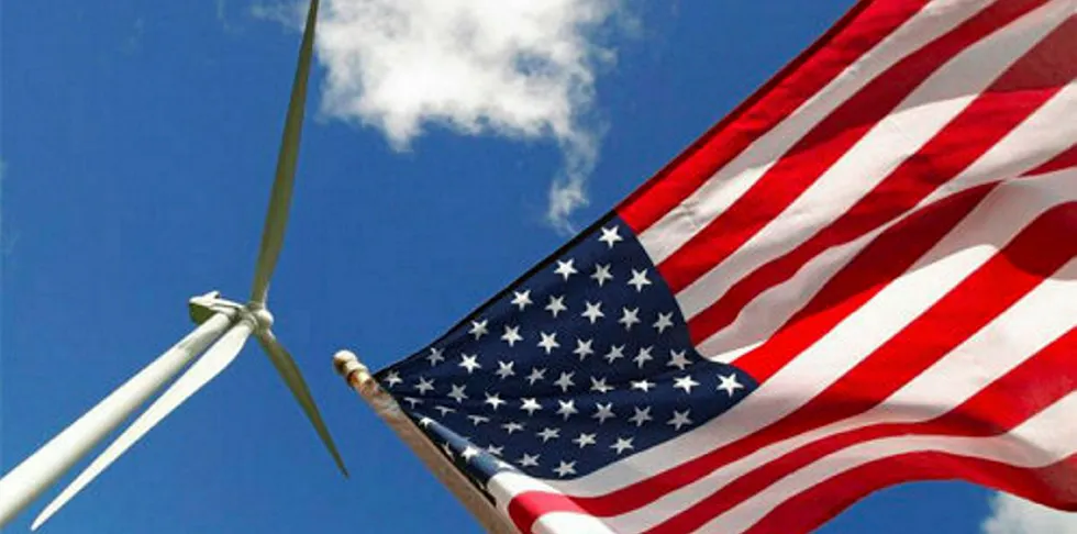 US flag flies near wind turbine