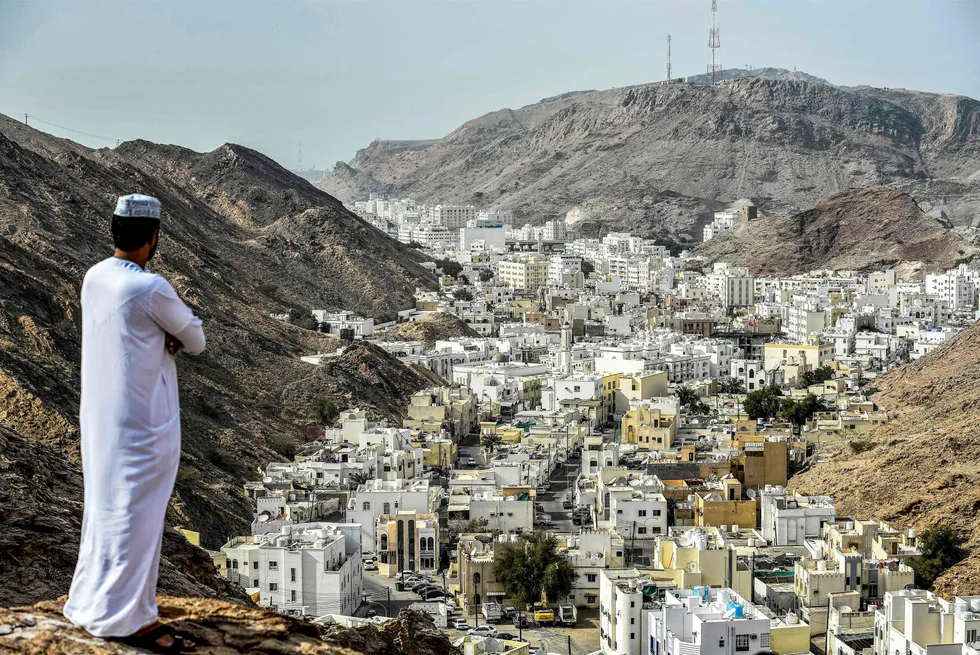 A man stands atop a hill in al-Wadi al-Kabir, west of Oman's capital city Muscat.