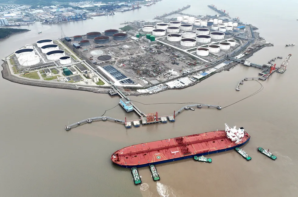 Tugboats help a crude tanker berth at an oil terminal in China’s Zhejiang province, in 2022.