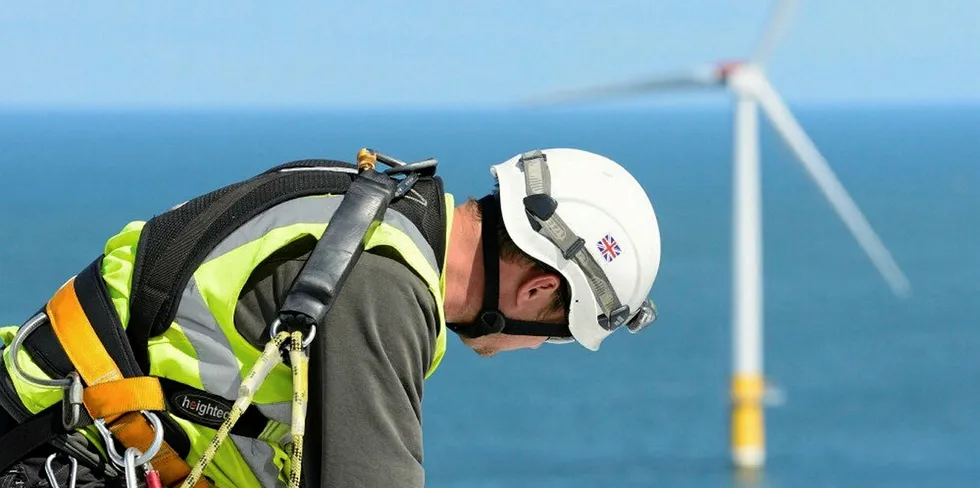An offshore wind service technician on a turbine.