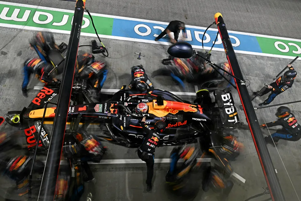 Team mechanics work on the car of Red Bull Racing's Dutch driver Max Verstappen in the pits during the Formula One Singapore Grand Prix.