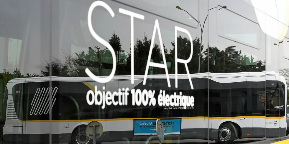 An electric bus "Bluebus" of the STAR (Rennes's conurbation public transport operator) reflected in the window of another during the "in-out" event for new mobilities in Chartres-de-Bretagne.