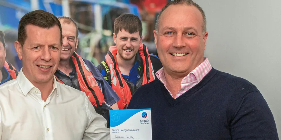 Scottish Sea Farms’ Managing Director Jim Gallagher (left) presenting Regional Production Manager for Shetland Graham Smith (right) with his 15-year certificate in 2019.