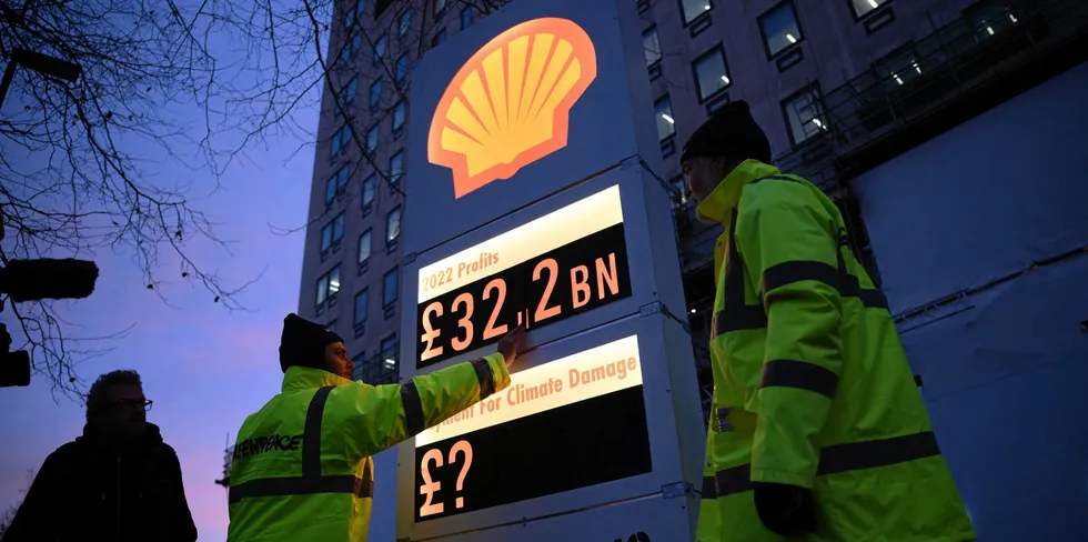 Activists from Greenpeace set up a mock-petrol station price board displaying Shell's net profit for 2022, as they demonstrate outside the company's headquarters in London.