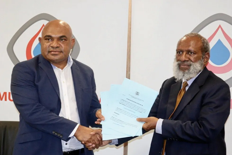 Ceremony: Kumul Petroleum's Wapu Sonk (left) and PNG Petroleum and Energy Minister Kerenga Kua (right)