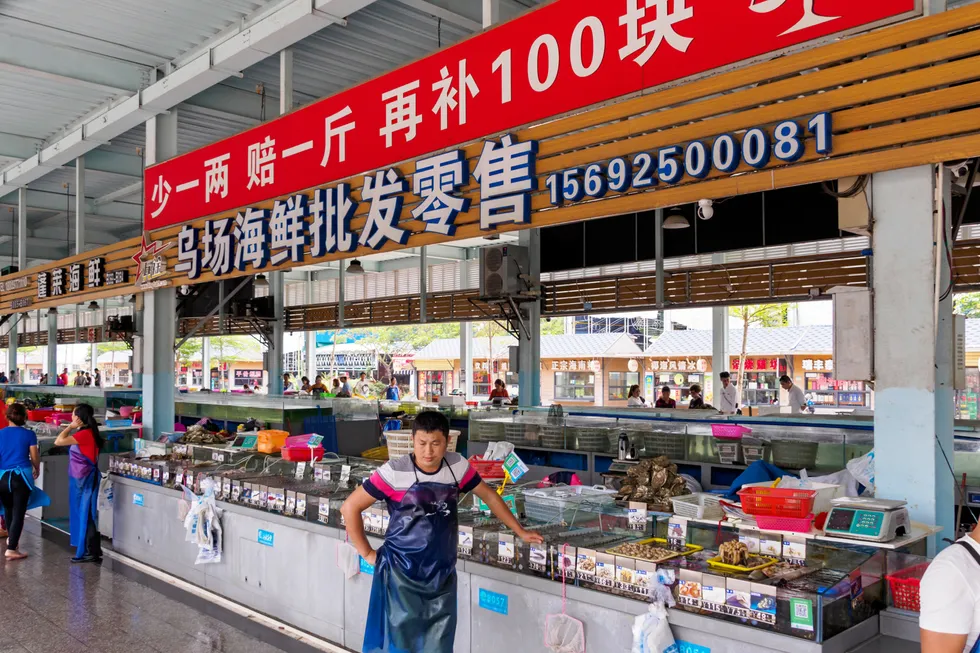 Stall owners at a seafood wholesale and retail wet market in Hainan, China.
