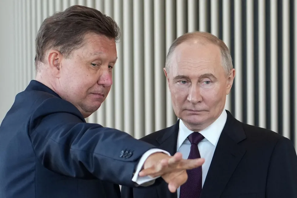 Gazprom executive chairman Alexei Miller with Russian President Vladimir Putin