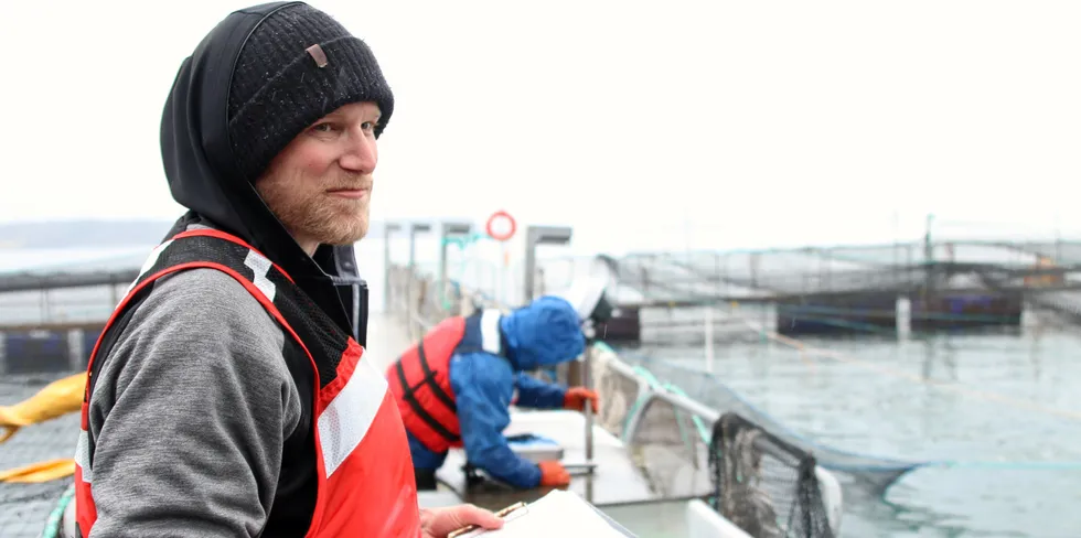 A worker at Cooke Aquaculture's Hope Island salmon farming site in Washington State.