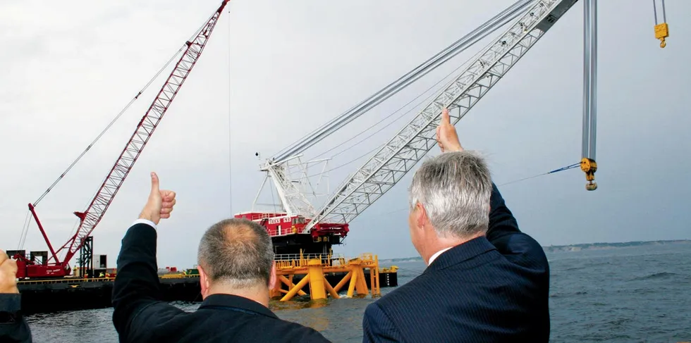 Erstwhile Deepwater Wind boss Jeff Grybowski and Rhode Island senator Sheldon Whitehouse give a thumbs-up to workers installing the first foundation at Block Island offshore wind farm in 2016