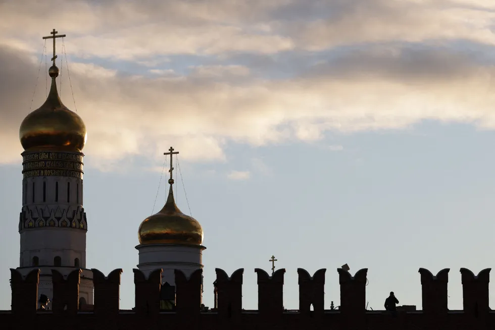 Repairing damage: A security guard stands at a site of a missing battlement of the Kremlin wall in Moscow after a major part of the brick battlement collapsed in a gust of hurricane wind in October 2021