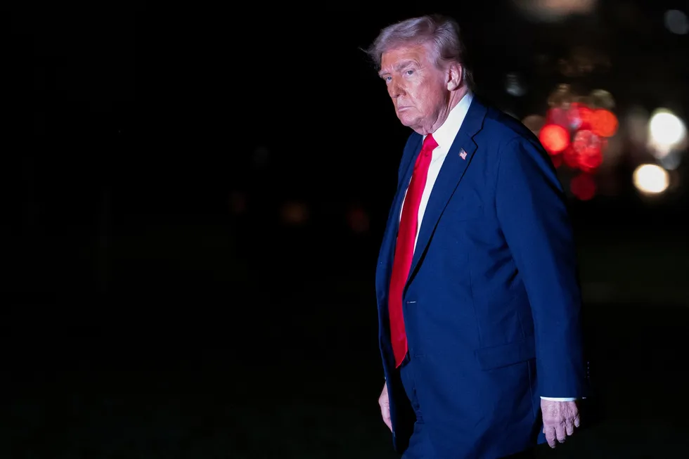 US President Donald Trump walks across the South Lawn while returning to the White House in Washington, DC, on Sunday.