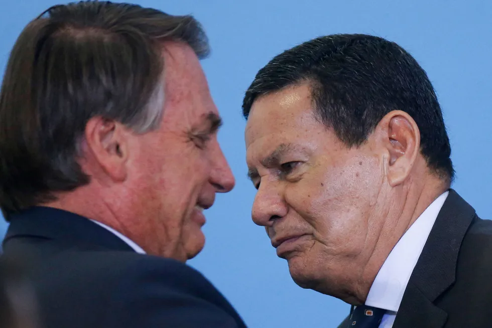 At odds: Brazilian President Jair Bolsonaro (left) greets Vice President Hamilton Mourao during a ceremony at the Planalto Palace in Brasilia