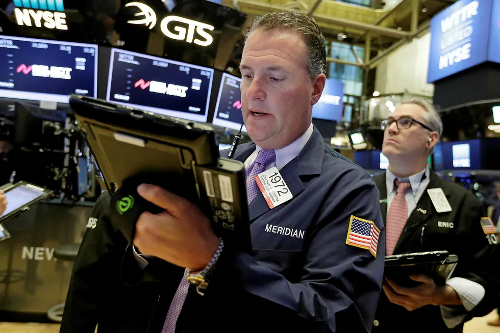 Watching the oil price: Traders Jonathan Corpina, left, and Eric Schumacher work on the floor of the New York Stock Exchange