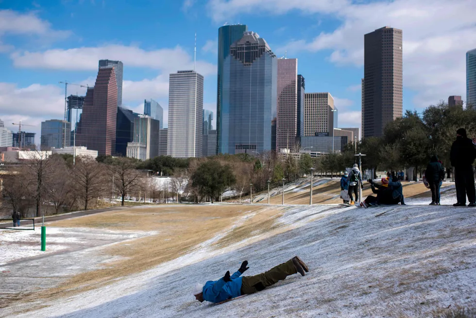 US cold snap: a man sleds down a snow covered hill in Houston, Texas on 15 February, 2021