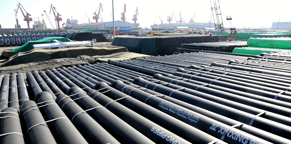 Cast steel pipes are discharged at the port waiting for shipment in Lianyungang, east China's Jiangsu Province