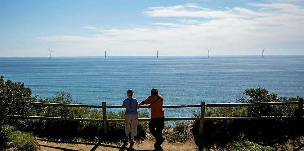 Tourists look out at the only US offshore wind farm, the 30MW Block Island array off the coast of Rhode Island