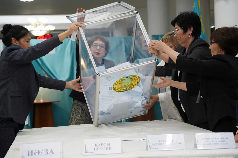 Resetting countdown: election commissioners prepare to remove ballots from a box to count them at a polling station in the Kazakhstan capital of Nur-Sultan on 5 June