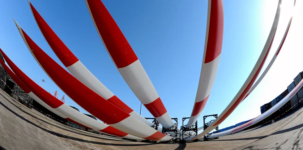 Wind turbine blades wait to be shipped aboard.