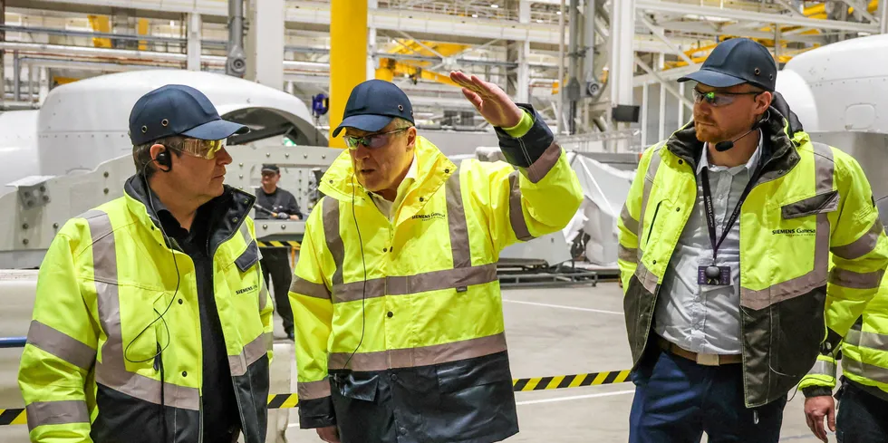 German Minister of Economics Robert Habeck (L) speaks with the CEO of Siemens Gamesa Jochen Eickholt (C) and the deputy plant manager Bjoern Christiansen (R) during his visit to the Siemens Gamesa factory in Cuxhaven, northwestern Germany.