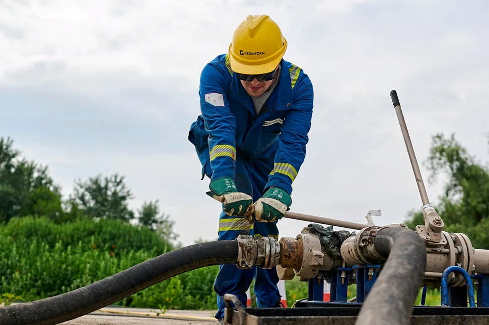 A worker operates an in-field hub with oil produced by MOL at the Vesces oilfield near Budapest in Hungary.