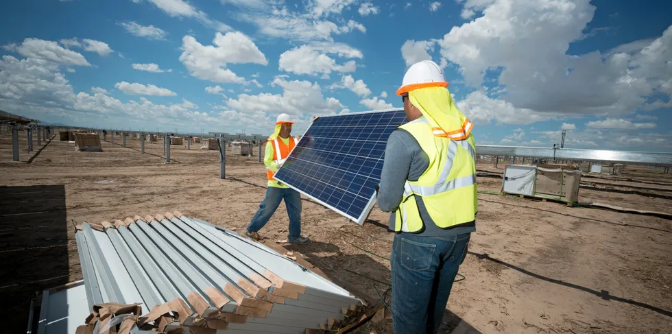 Installation workers with Swinerton, one of the largest solar EPC players in the US