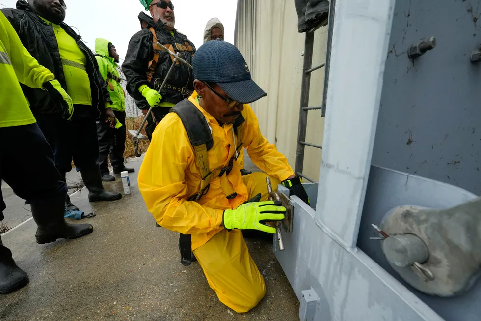 A worker from the Southeast Louisiana Flood Protection Authority-West locks a floodgate along the Harvey Canal, just outside the New Orleans city limits, in anticipation of Hurricane Francine in Harvey, Louisiana on Tuesday, 10 September 2024.