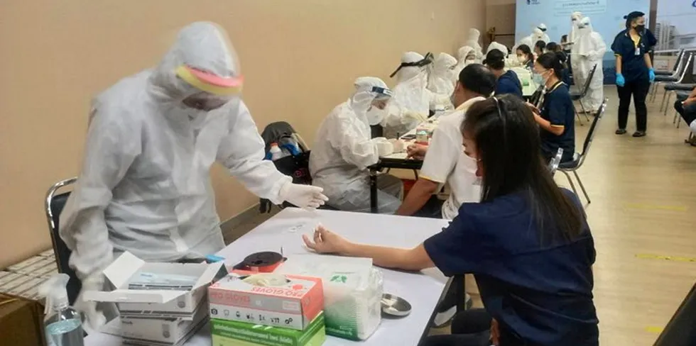 . Thai Union workers are tested for COVID-19 in Samut Sakhon, Thailand.