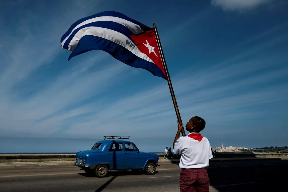 A Cuban waves the national flag in Havana.