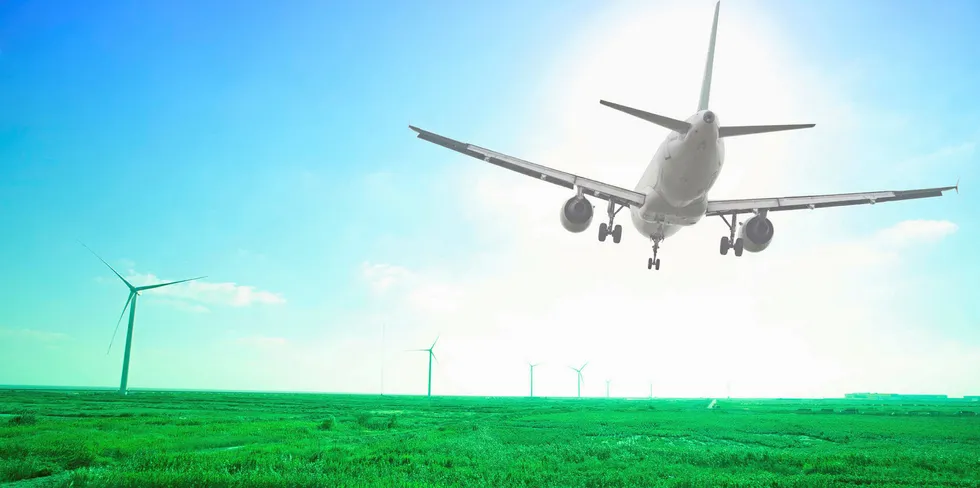 Rendering of an airplane over a wind farm.