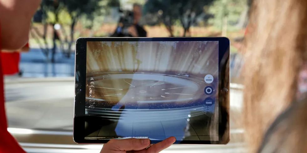 An augmented reality feature shows how solar energy will be captured from the Apple Park panels at the Apple Park Visitor Center in Cupertino, California.