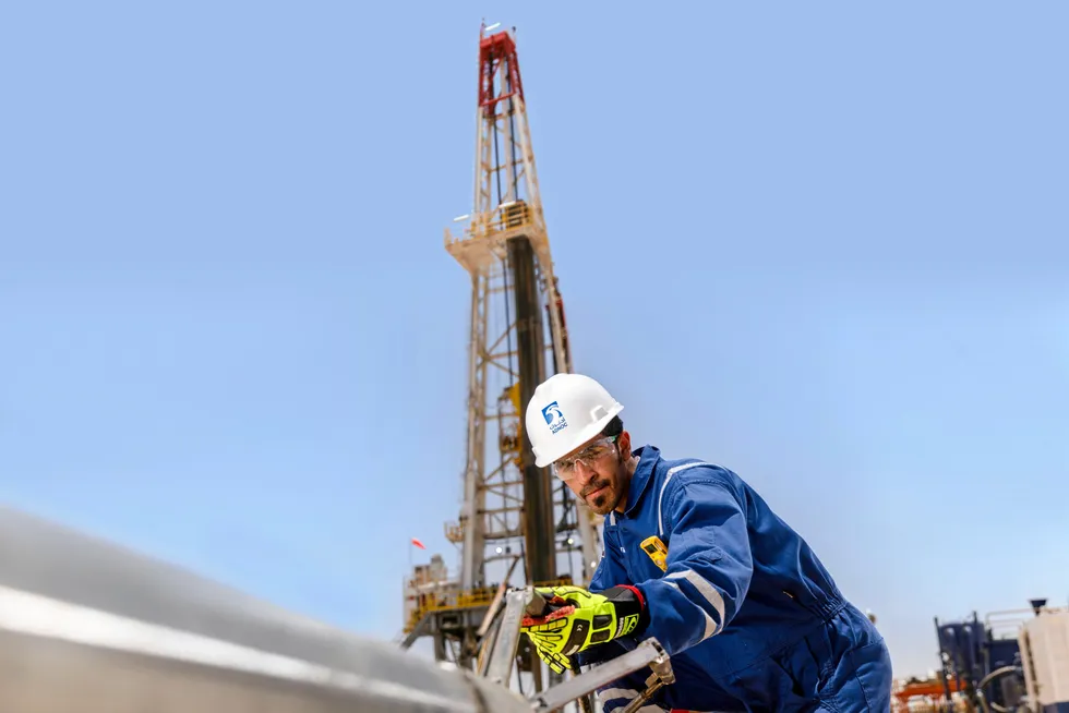 Gas compression: an Adnoc worker at a wireline truck in Abu Dhabi.