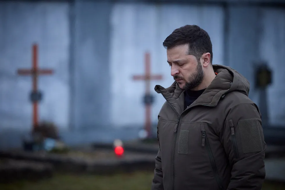 Sombre: Ukraine President Volodymyr Zelensky pays tribute to fallen soldiers at a cemetery in Lviv in January.