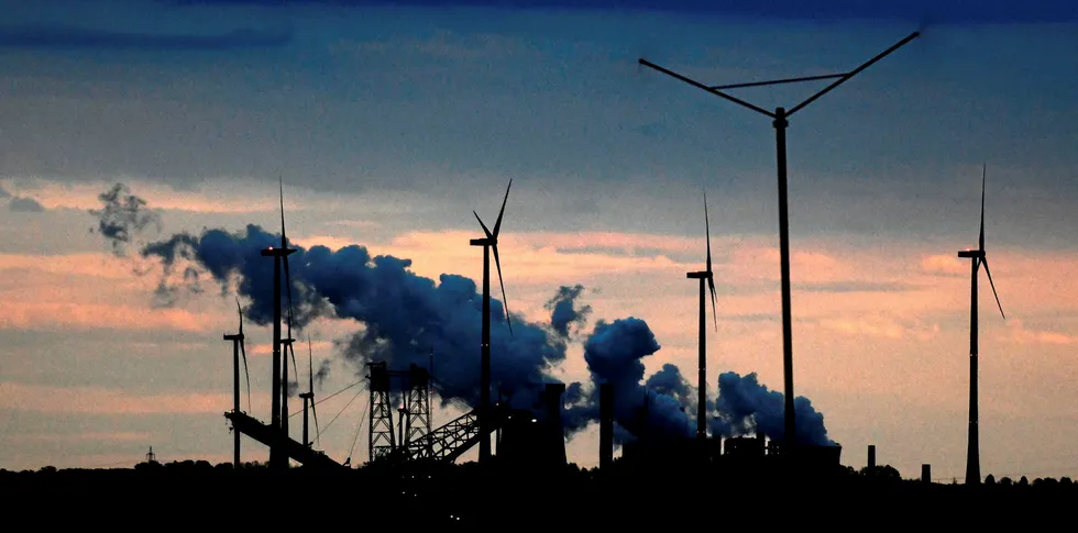 Coal-fired power plants and wind turbines at utility RWE's Garzweiler lignite opencast mine in Jackerath, Germany