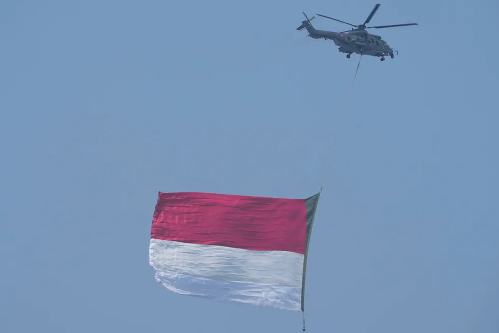 A giant Indonesian flag is unfurled during a ceremony marking the country's 78th anniversary of independence on 17 August 2023.