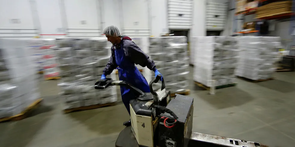 A forklift operator zooms past pallets of Imported frozen seafood from China inside the refrigerated warehouse at Pacific American Fish Company imports (PAFCO) in Vernon, California.