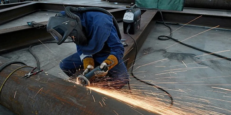 Welder works on the hull of a boat at Mainstay Marine Solutions' shipyard in Milford Haven in Wales