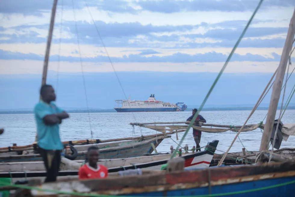 Fishermen wait at their boats at the port of Paquitequete near Pemba on 29 March 2021. Sailing boats are expected to arrive with people displaced from the coasts of Palma and Afungi after suffering attacks by armed groups